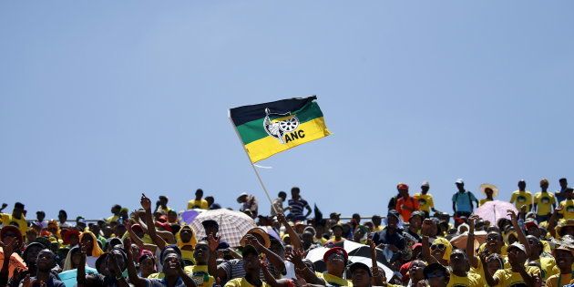 Supporters of the African National Congress (ANC) wave a party flag during the party's 104th anniversary celebrations in Rustenburg, South Africa January 9, 2016. REUTERS/Siphiwe Sibeko TPX IMAGES OF THE DAY