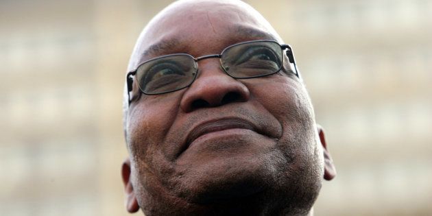 Former South African deputy-President Jacob Zuma smiles at supporters after his acquittal on rape charges, in the Johannesburg High Court May 8, 2006. A South African judge on Monday acquitted Zuma of raping an HIV-positive family friend, ending a case that opened deep rifts in the ruling African National Congress.