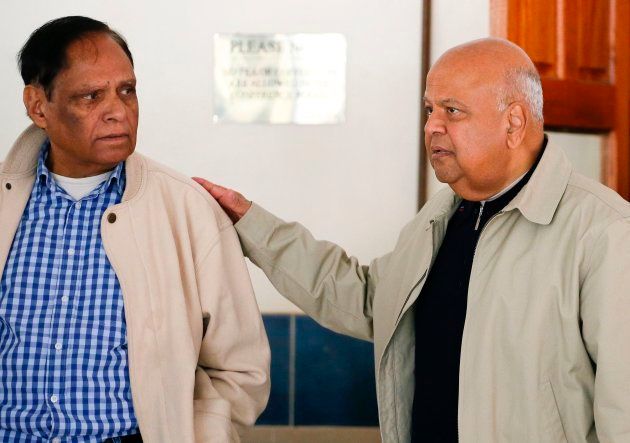 Former finance minister Pravin Gordhan (R) arrives to attend the South African ruling Party African National Congress 's ordinary National Executive Committee meeting on May 27, 2017 in Pretoria, South Africa. / AFP PHOTO / Phill Magakoe (Photo credit should read PHILL MAGAKOE/AFP/Getty Images)