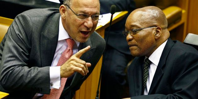 South Africa's Finance Minister Trevor Manuel chats with ruling African National Congress President Jacob Zuma in Parliament in Cape Town during the swearing in of members and the formal election of the country's president, May 6, 2009.