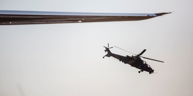 A Denel Rooivalk attack helicopter flies by during the Africa Aerospace and Defence Fair 2016 at South Africa's Waterkloof air force base on September 15 2016.