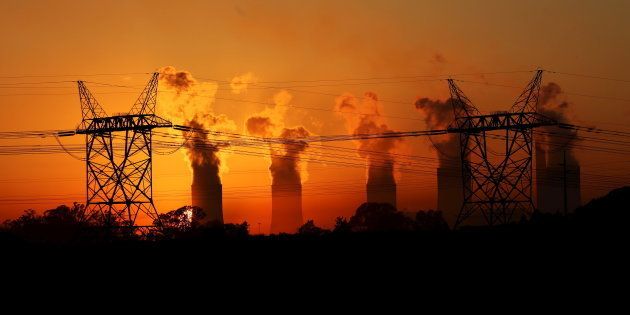 Electricity pylons are seen in front of the cooling towers at the Lethabo Thermal Power Station, an Eskom coal-burning power station near Sasolburg.