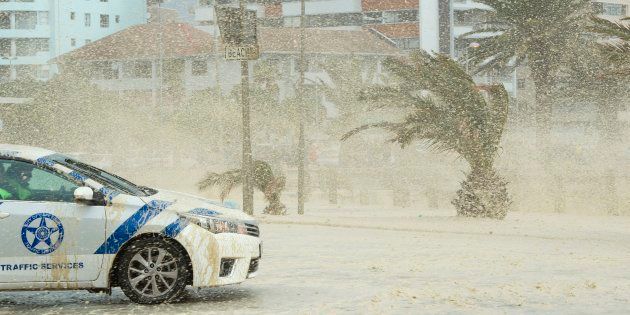 Waves of foam and seawater crash into Three Anchor Bay in Cape Town on June 7 2017, as an intense storm hits South Africa's west coast.