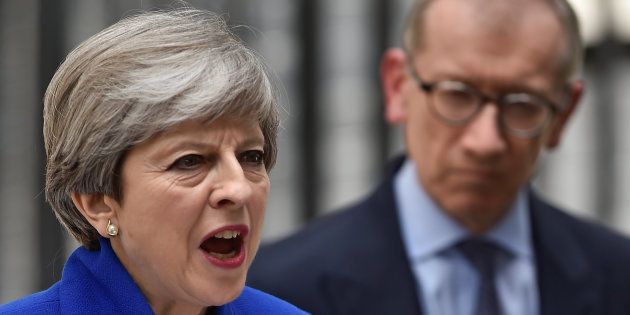 Britain's Prime Minister Theresa May addresses the country as her husband looks on after Britain's election at Downing Street in London. REUTERS/Hannah Mckay