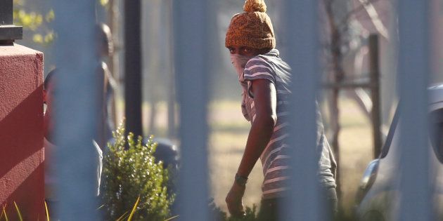 A masked student at the University of the Western Cape flees as police open fire with rubber bullets and teargas during protests demanding free tertiary education in Cape Town, South Africa, October 19, 2016. REUTERS/Mike Hutchings