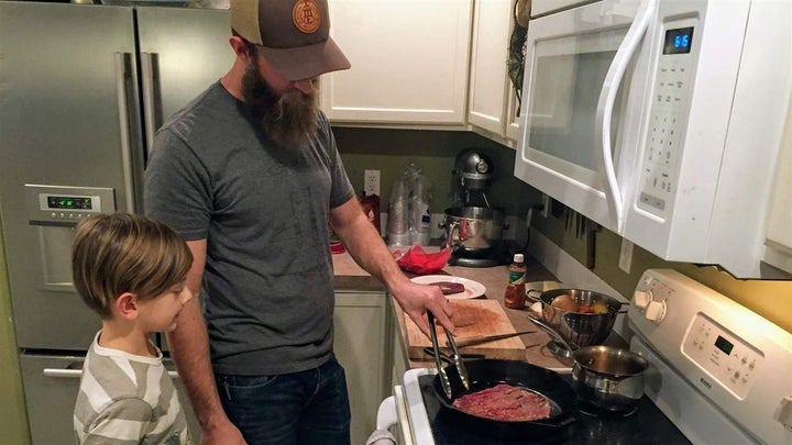 <p>Nate Lindskoog and his son Jett, 8, cook venison tacos in their Nampa, Idaho, home. The deer was killed by a car a year earlier.</p>