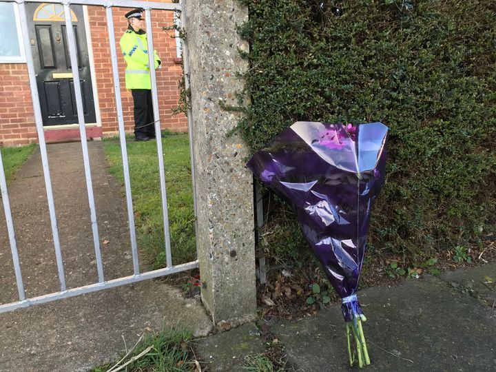 Floral tributes at the property where the victims were found 