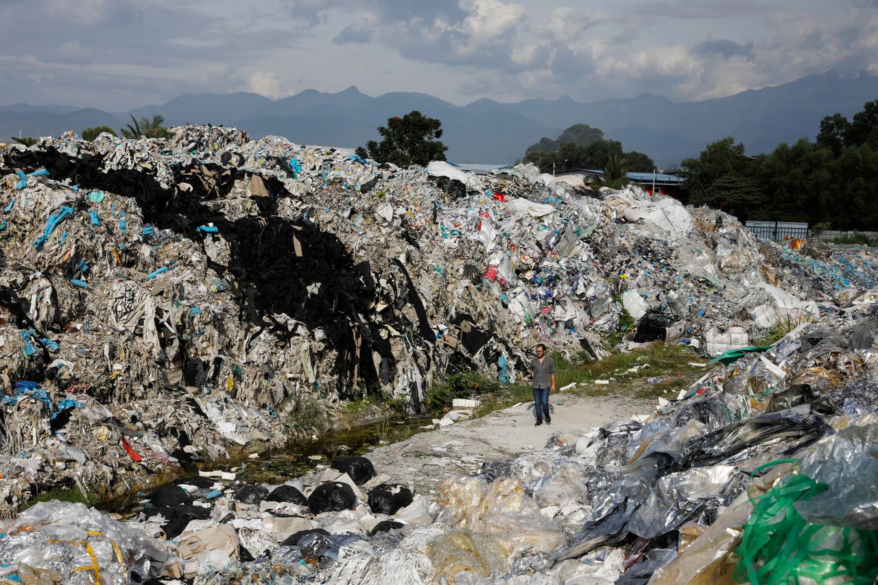 A Greenpeace activist at a dumpsite in Ipoh, Jan. 30. Unlicensed recyclers are illegally burning or dumping waste plastics in Malaysia.