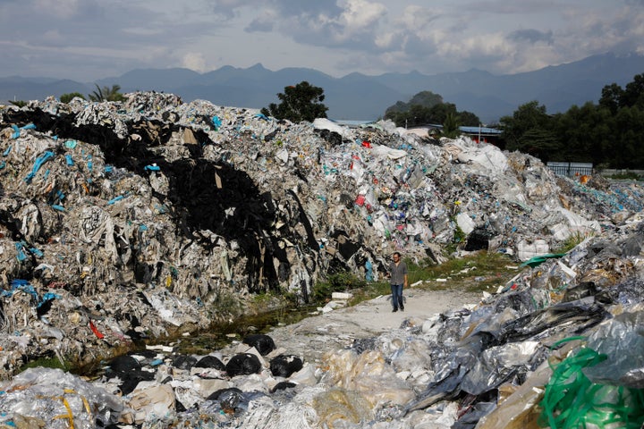 A Greenpeace activist at a dumpsite in Ipoh, Malaysia, on Jan. 30. Unlicensed recyclers are illegally burning or dumping waste plastics at sites across the country.