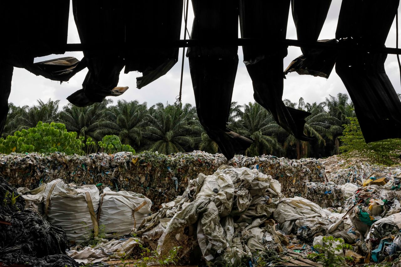 Plastic bales behind burned fencing at an illegal recycling site near Jenjarom, Malaysia, Feb. 2. After China, long the world’s largest importer of recyclables, banned importing 24 categories of recyclable waste in 2018, Malaysia became the world’s largest importer of plastic scrap.