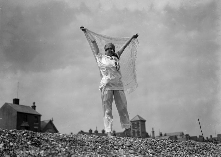 A woman wearing her beach pajamas on a beach in England, dated 1927.