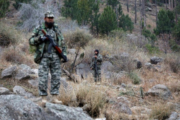 Pakistani soldiers stand guard near the area that India carried out airstrikes on 26