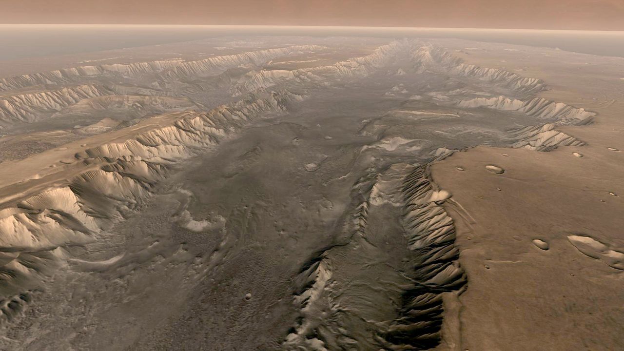 Mars' own Grand Canyon, Valles Marineris, is shown on the surface of the planet in this composite image made aboard NASA's Mars Odyssey spacecraft. The image was taken from a video featuring high-resolution images from Arizona State University's Thermal Emission Imaging System multi-band camera on board the spacecraft. The mosaic was then colored to approximate how Mars would look to the human eye. Valles Marineris is 10 times longer, five times deeper and 20 times wider than Earth's Grand Canyon. (Photo by NASA/Arizona State University via Getty Images)