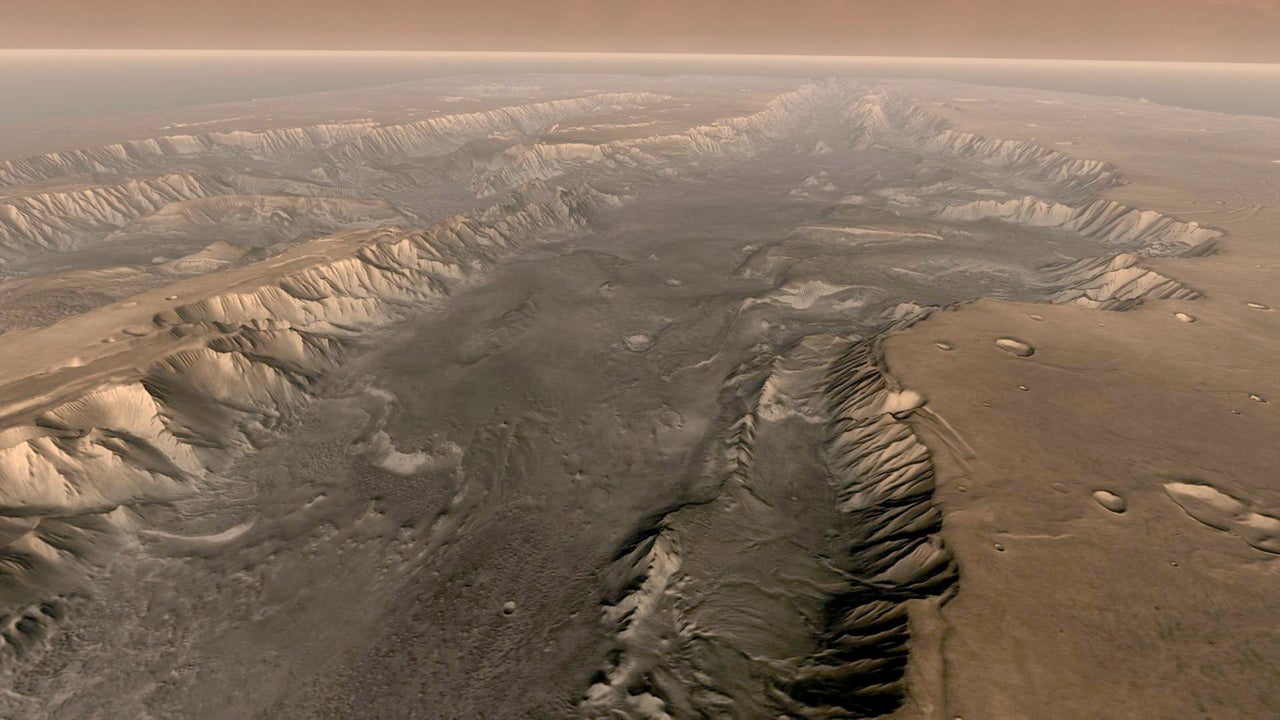 Mars' own Grand Canyon, Valles Marineris, is shown on the surface of the planet in this composite image made aboard NASA's Mars Odyssey spacecraft. The image was taken from a video featuring high-resolution images from Arizona State University's Thermal Emission Imaging System multi-band camera on board the spacecraft. The mosaic was then colored to approximate how Mars would look to the human eye. Valles Marineris is 10 times longer, five times deeper and 20 times wider than Earth's Grand Canyon. (Photo by NASA/Arizona State University via Getty Images)