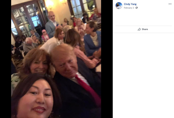 A screenshot taken from Li "Cindy" Yang's Facebook page shows her seated behind the president.