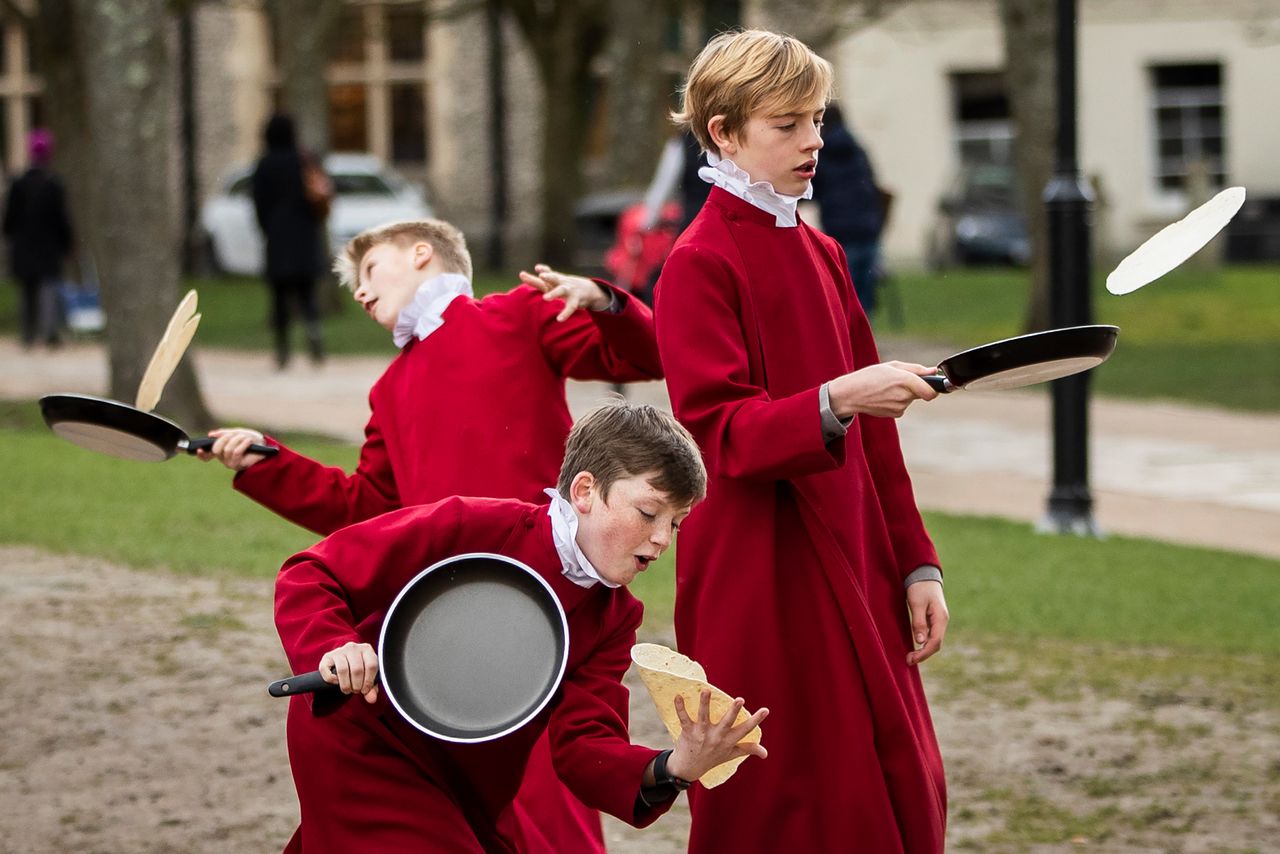 Choristers from Winchester Cathedral joke around in between being posed up for pictures by photographers on March 5, 2019, in Winchester, England. Winchester Cathedral held it's inaugural Shrove Tuesday/Pancake Day race in the Cathedral grounds, with money raised going to local charities.