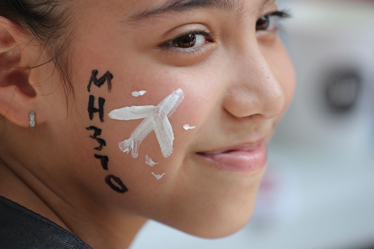 In this March 3, 2019, photo, a girl has her face painted with a missing plane during a Day of Remembrance for MH370 event in Kuala Lumpur, Malaysia. Five years ago, Malaysia Airlines Flight MH370, a Boeing 777, had gone missing the day before while over the South China Sea with 239 people on board.