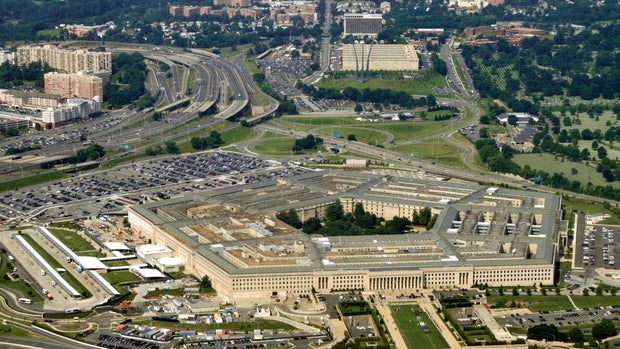 Aerial of the Pentagon, the Department of Defense headquarters in Arlington, Virginia, near Washington DC, with I-395 freeway on the left, and the Air Force Memorial up middle.