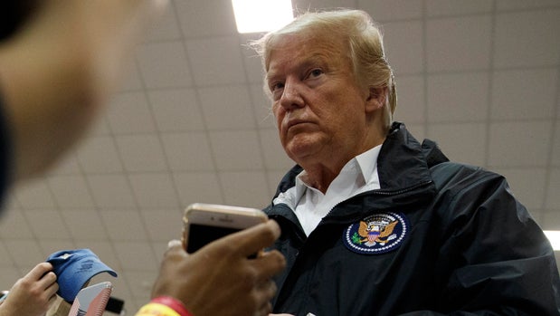 President Donald Trump greets people at Providence Baptist Church in Smiths Station, Ala., Friday, March 8, 2019, during a tour of where tornados killed 23 people in Lee County, Ala. (AP Photo/Carolyn Kaster)