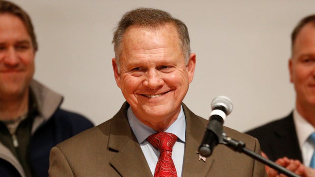 Republican U.S. Senate candidate Roy Moore addresses supporters as his wife Kayla (R) looks on at his election night party in Montgomery, Alabama, U.S., December 12, 2017. REUTERS/Jonathan Bachman