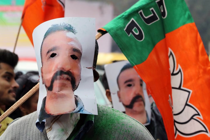 People wear masks in the likeness of Indian Air Force pilot Abhinandan Varthaman and hold Bharatiya Janata Party flags during a rally in New Delhi, India, on Saturday, March 2, 2019.