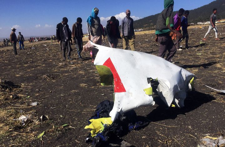 People walk past a part of the wreckage at the scene of the Ethiopian Airlines Flight ET 302 plane crash, near the town of Bishoftu, southeast of Addis Ababa, Ethiopia March 10, 2019.