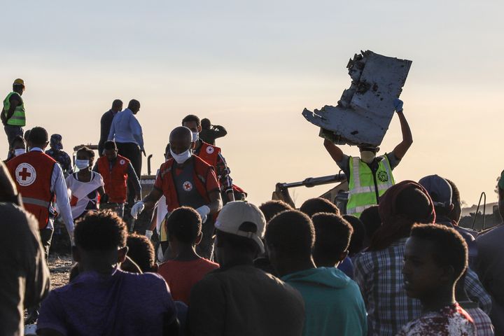A man carries a piece of debris on his head at the crash site of a Nairobi-bound Ethiopian Airlines flight near Bishoftu, a town some 60 kilometres southeast of Addis Ababa, Ethiopia, on March 10, 2019. 