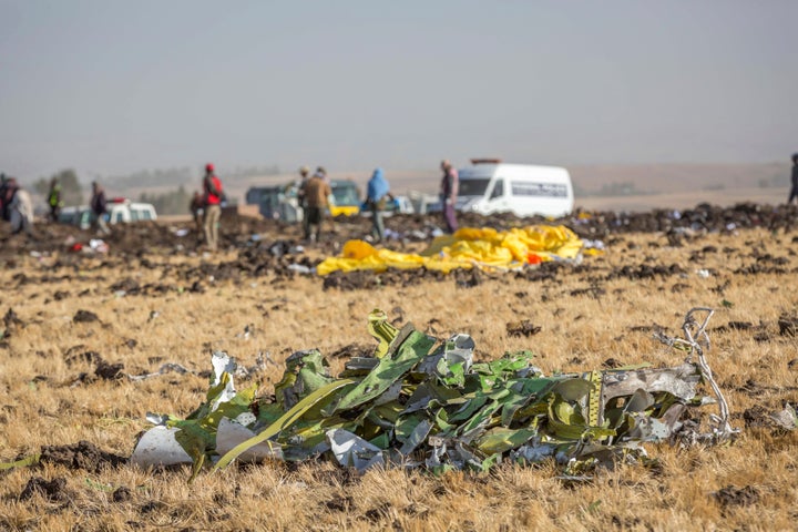 Parts of the plane wreckage with rescue workers at the crash site at Bishoftu, or Debre Zeit, outside Addis Ababa, Ethiopia, Monday, March 11, 2019, where Ethiopia Airlines Flight 302 crashed Sunday.