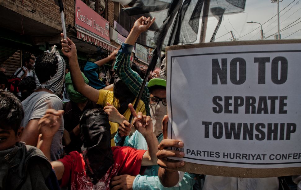 Kashmir Muslim protesters shout anti-India slogans during a protest against setting up of housing colonies in Srinagar. 
