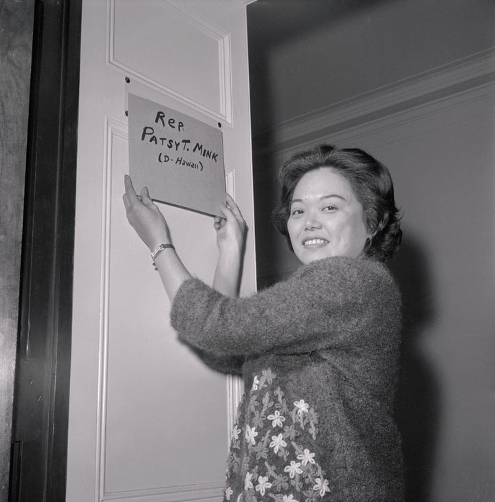 Patsy Mink puts a homemade nameplate on the door of her office after being elected to the 89th Congress. 