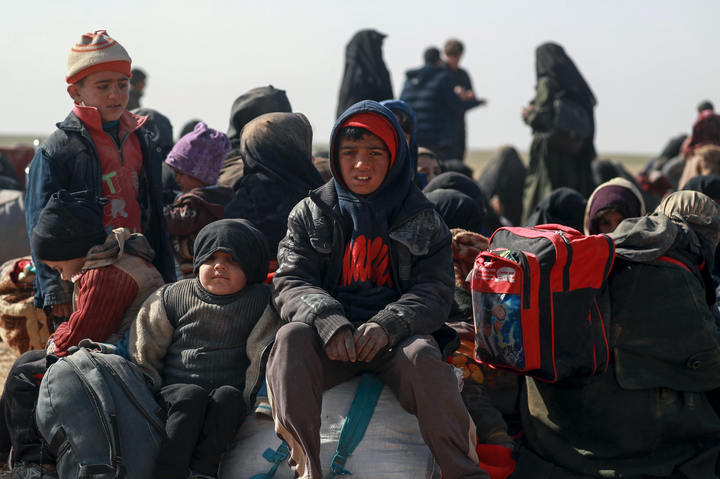 Families fleeing their homes in the village of Baghouz, Syria, for a displaced people’s camp nearly 200 miles away, Jan. 26. UNICEF estimated that 1,106 children were killed amid the country’s civil war in 2018.