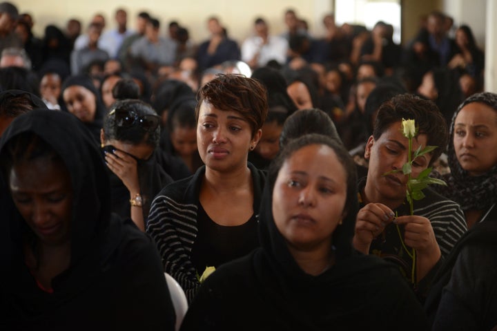 Mourners attend a memorial service Monday for Ethiopian Airlines crew members and other victims of the crash near Addis Ababa, Ethiopia.