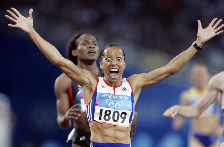 Dame Kelly Holmes celebrating at the 2004 Olympics. 