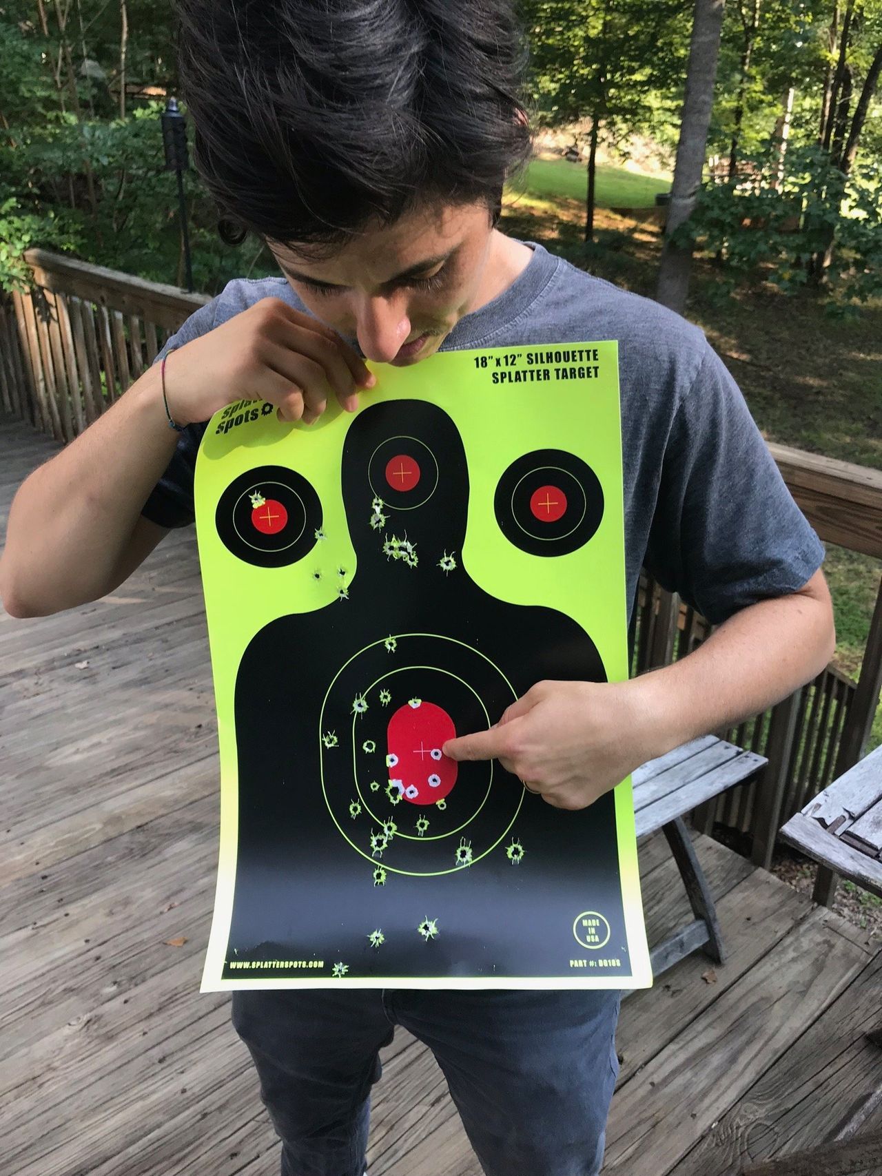 Mel Plaut pointing out the first shot they ever took, a bullseye with a .22 (hence the tiny hole), in August 2018.