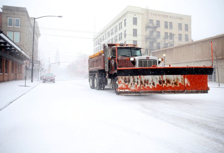 A snow plow rumbles north on Capitol Avenue during a blizzard on Wednesday, March 13, 2019, in Cheyenne, Wyo. (Jacob Byk/The Wyoming Tribune Eagle via AP)