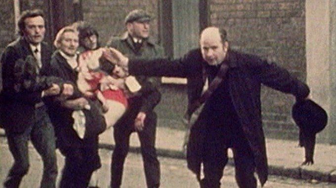 The iconic image of Bishop of Derry Edward Daly waving a white handkerchief while escorting the fatally wounded 17-year-old Jackie Duddy.