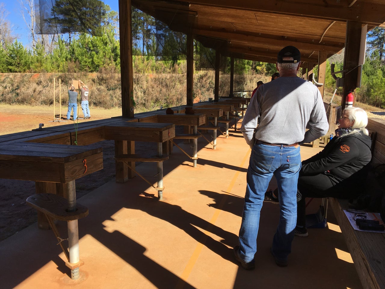 Some fellow shooters wait around while others set up their targets during a cease-fire at Cedar Creek, in January 2019.