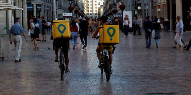 Delivery drivers for Glovo cycle in downtown Malaga, Spain, June 7, 2018. REUTERS/Jon