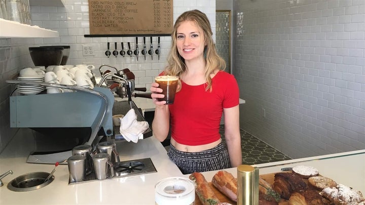 Anna Buck, a barista, holds a cup of CBD-infused cold brew at Blue Sparrow Coffee in Denver. Federal regulators say businesse