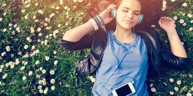 Girl lying down in the grass - copyspace