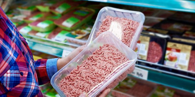Buyer chooses minced meat in a