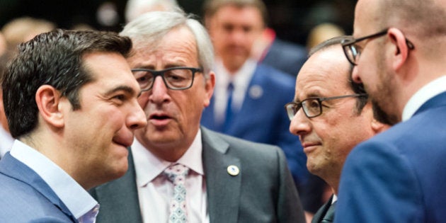 Greek Prime Minister Alexis Tsipras, left, speaks with, from left, European Commission President Jean-Claude Juncker, French President Francois Hollande and Belgian Prime Minister Charles Michel during a meeting of eurozone heads of state at the EU Council building in Brussels on Sunday, July 12, 2015. Skeptical European creditors raced Sunday to narrow differences both among themselves and with Athens, aiming to come up with a tentative agreement to stave off an immediate financial collapse in Greece that would reverberate across the continent. (AP Photo/Geert Vanden Wijngaert)