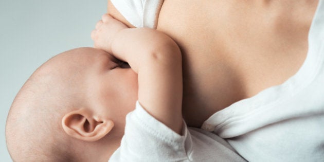 Baby feeds on MOM's breasts