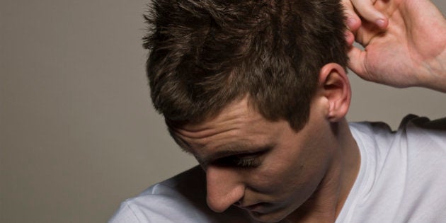 Man scratching head