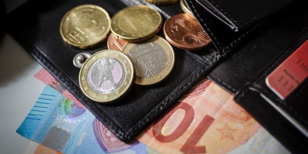 Berlin, Germany - August 23: Euro banknotes and Euro coins lying in a wallet on August 23, 2016 in Berlin, Germany. (Photo by Thomas Trutschel/Photothek via Getty Images)