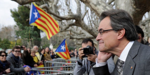 President of the Catalonian regional government Artur Mas gestures as he listens to independentist people outside Catalonia's parliament after a vote for a petition to the national parliament in Barcelona on January 16, 2014. The Catalan Parliament voted 87 to 43 with 3 abstentions, demanding Madrid the authorization to organise an independance referendum. AFP PHOTO/ JOSEP LAGO (Photo credit should read JOSEP LAGO/AFP/Getty Images)