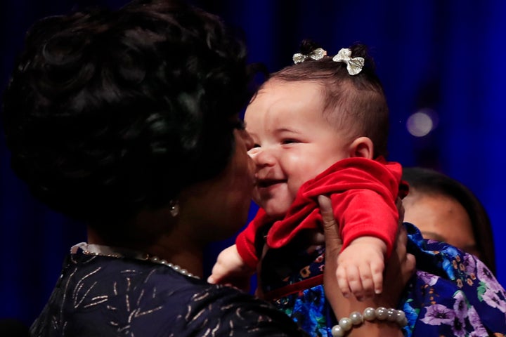 Muriel Bowser kisses her daughter, after being sworn in as mayor of the District of Columbia, Jan. 2, 2019.