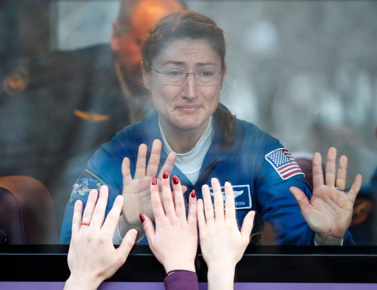 International Space Station crew member Christina Koch of the U.S. looks out a bus window before leaving for pre-flight preparation at the Baikonur Cosmodrome in Kazakhstan on March 14, 2019.