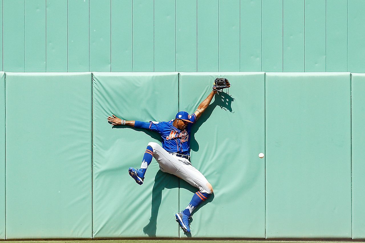 Keon Broxton of the New York Mets crashes into the wall as he attempts to catch a fly ball in the sixth inning of a Grapefruit League spring training game against the Boston Red Sox in Fort Myers, Florida, on March 9, 2019.