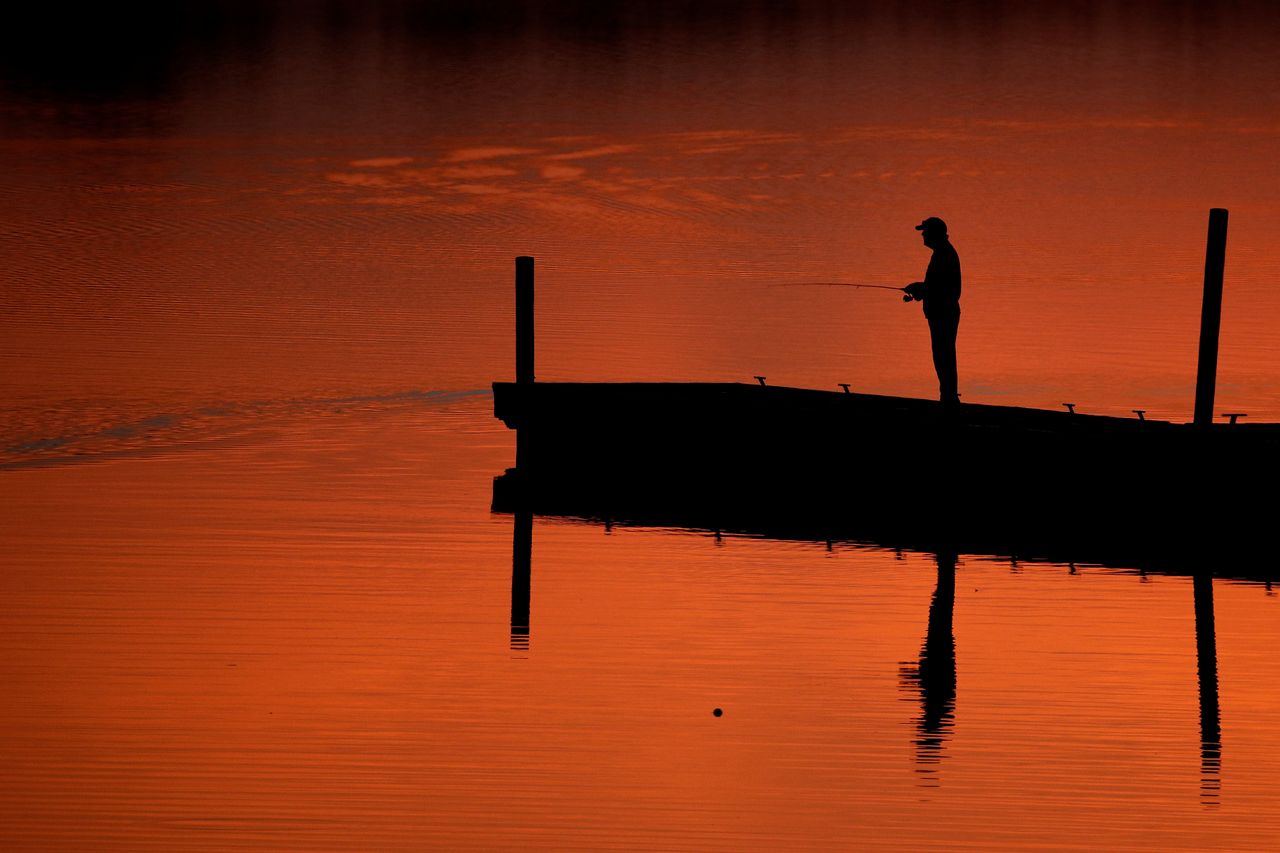 A man fishes on a dock at Shawnee Mission Park in Lenexa, Kansas, on March 11, 2019.